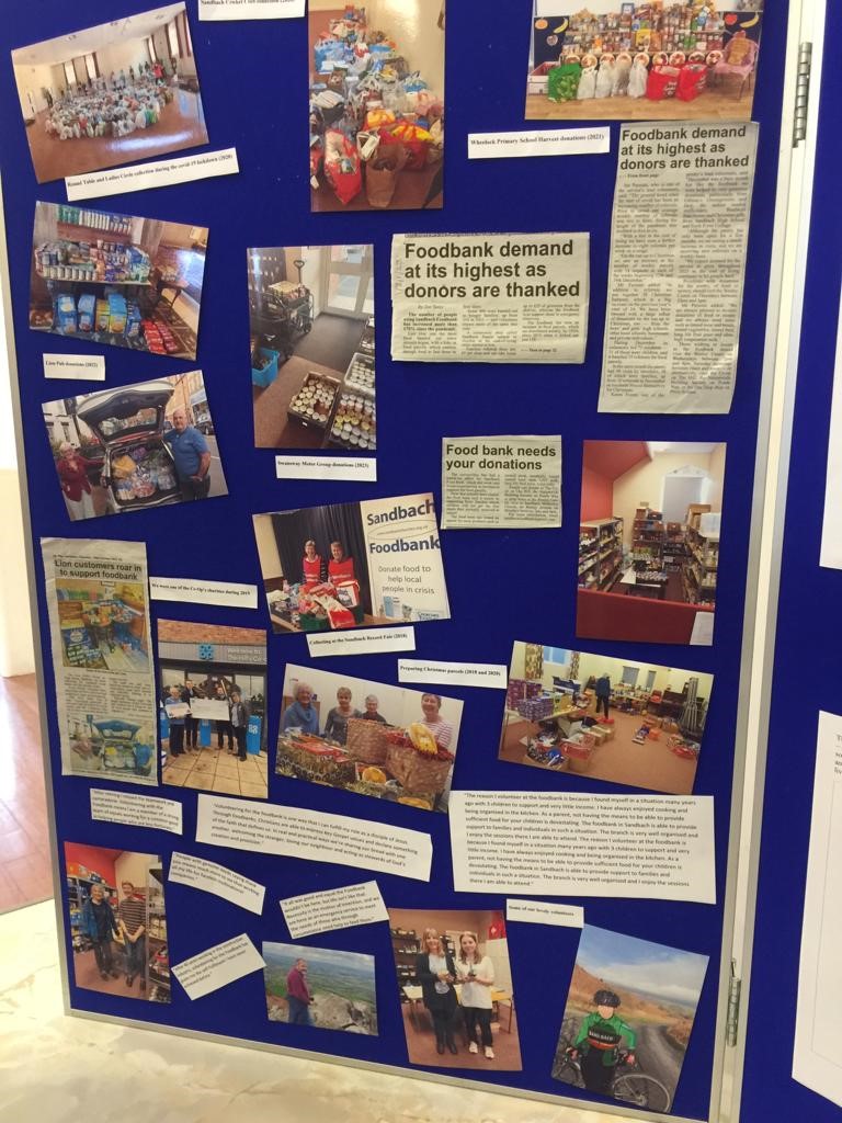 A board of pictures and news clippings about the foodbank