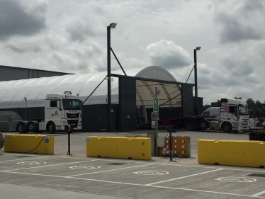 Vehicle hangar and trucks on a car park