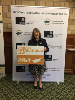 Fiona Bruce MP in front of a banner